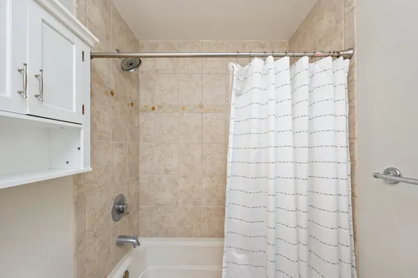 a bathroom with a shower and a tub