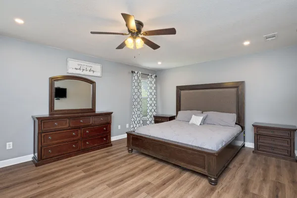 a bedroom with a bed and a dresser