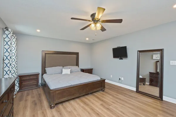 a bedroom with a bed and a flat screen tv