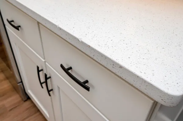 a aerial view of a house next to a yard and large trees