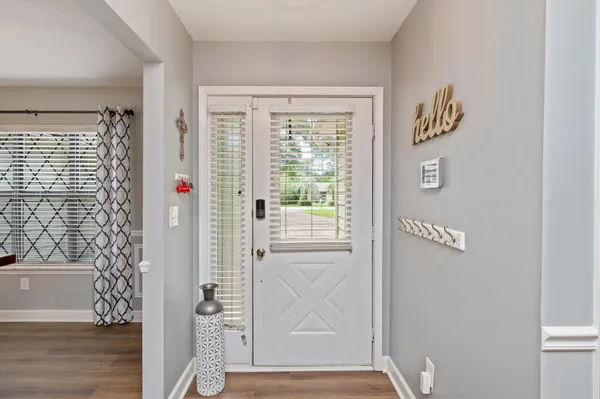 a view of front door and wooden floor