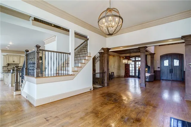 a kitchen with stainless steel appliances kitchen island wooden floors and white cabinets