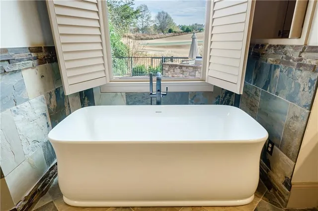 an open kitchen with a sink and wooden floor