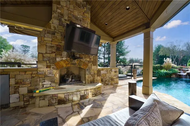 a outdoor living space with patio furniture and a fireplace