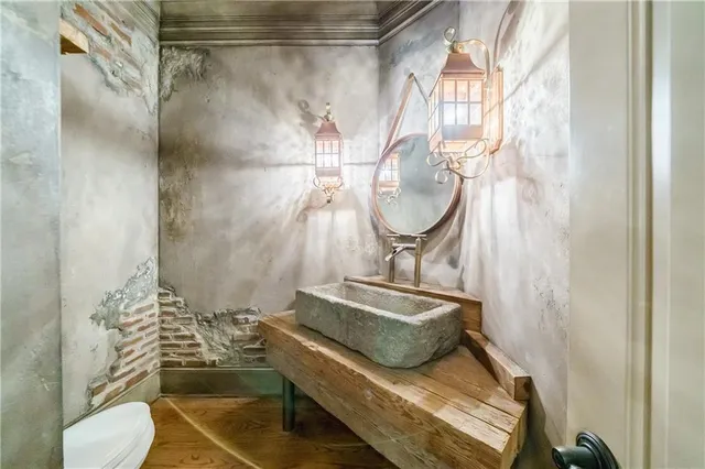 a view of an empty room and kitchen with fireplace