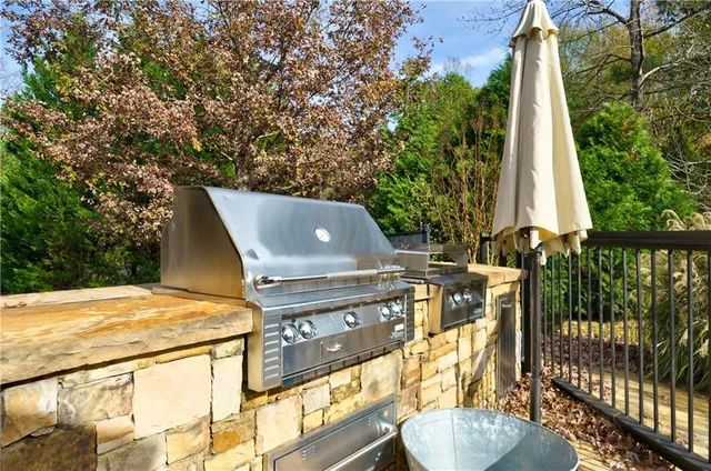 a front view of a house with a yard and potted plants