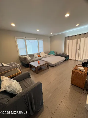 a bed room with furniture and window