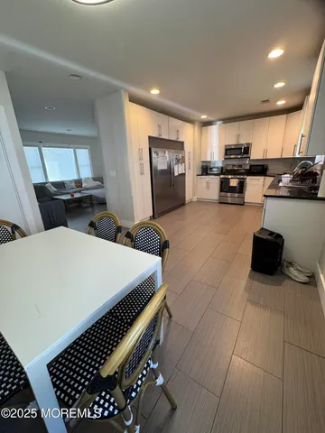 a kitchen with a sink a stove and cabinets