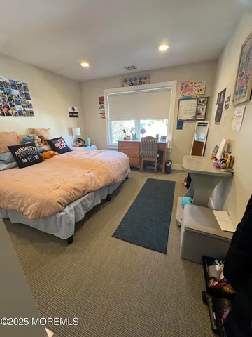 a spacious bedroom with a bed and window