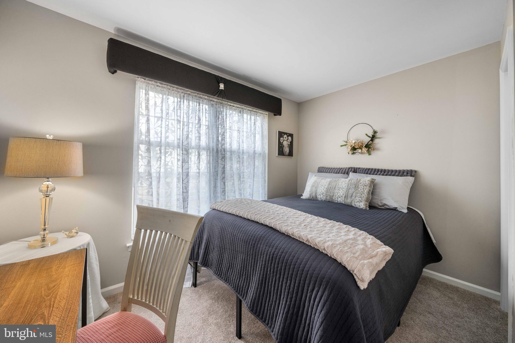 18 Savoy Road Newark, DE 19702 - Photo 15 of 44 a bedroom with a bed and a lamp next to a window