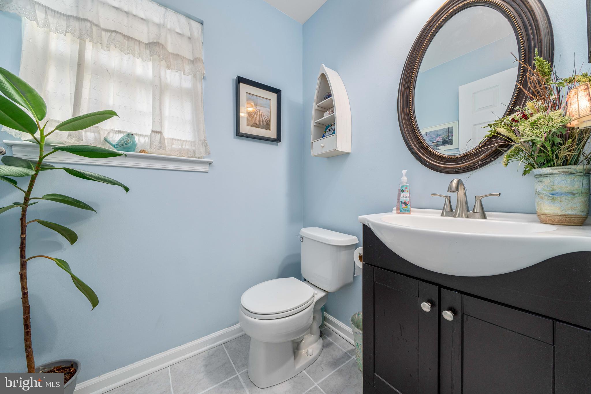 18 Savoy Road Newark, DE 19702 - Photo 16 of 44 a bathroom with a toilet a sink and a mirror