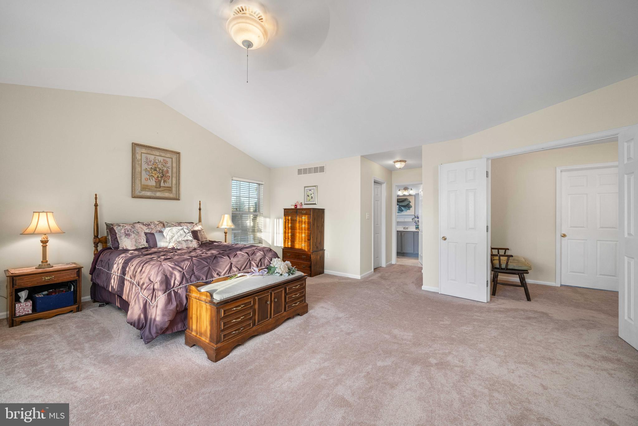 18 Savoy Road Newark, DE 19702 - Photo 23 of 44 a spacious bedroom with a bed and a chandelier