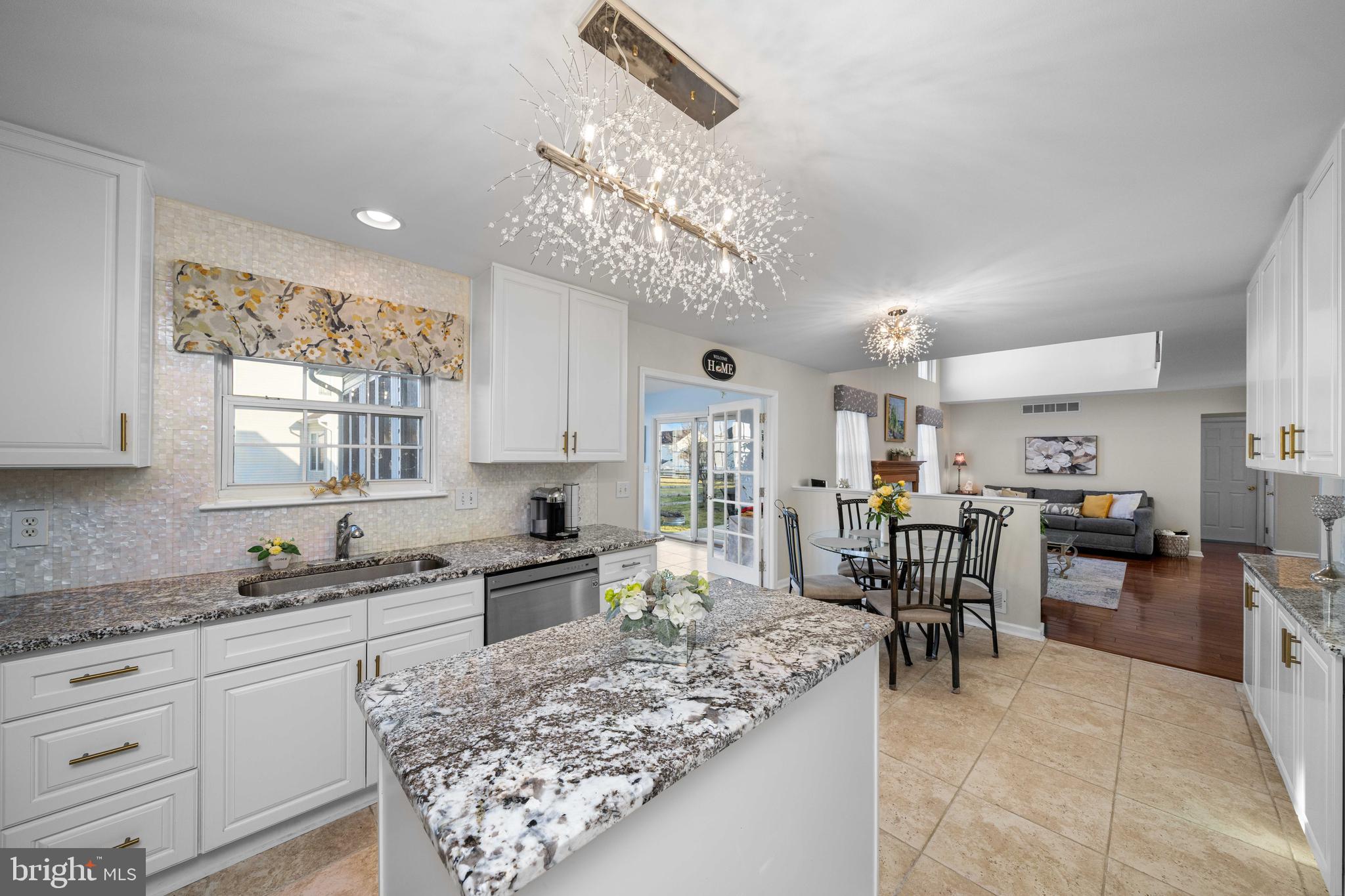 18 Savoy Road Newark, DE 19702 - Photo 8 of 44 a large kitchen with kitchen island a large counter space dining table and stainless steel appliances