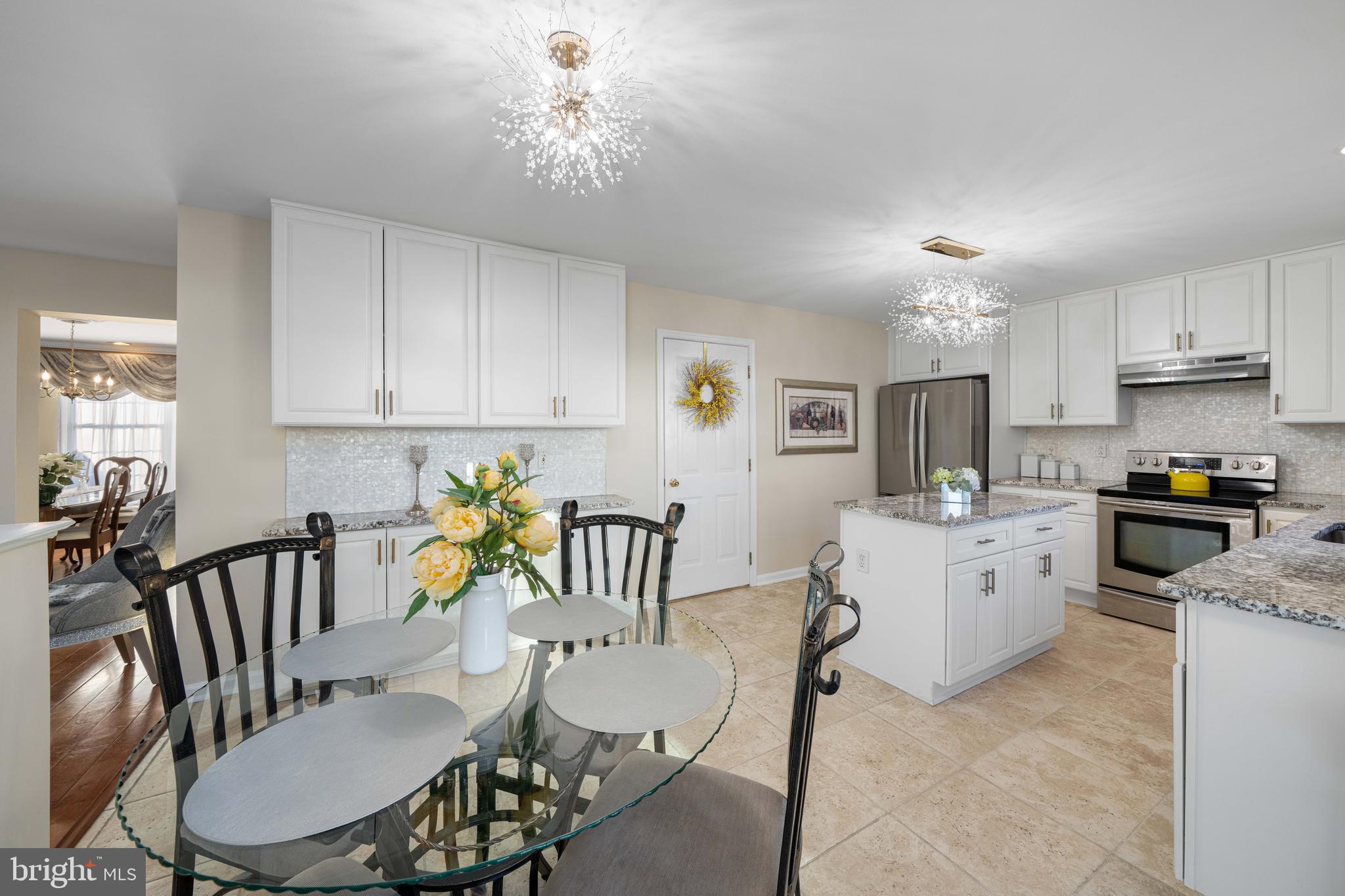 18 Savoy Road Newark, DE 19702 - Photo 10 of 44 a kitchen with a dining table chairs and white appliances