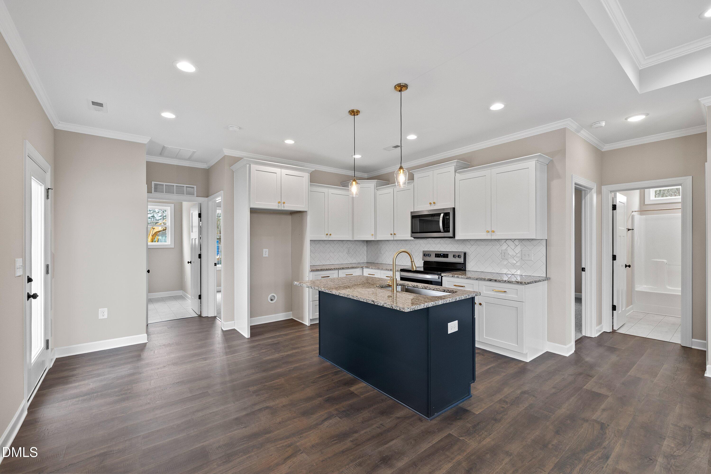 920 Micro Road West Selma, NC 27576 - Photo 12 of 32 a kitchen with stainless steel appliances kitchen island granite countertop a refrigerator a sink and a stove
