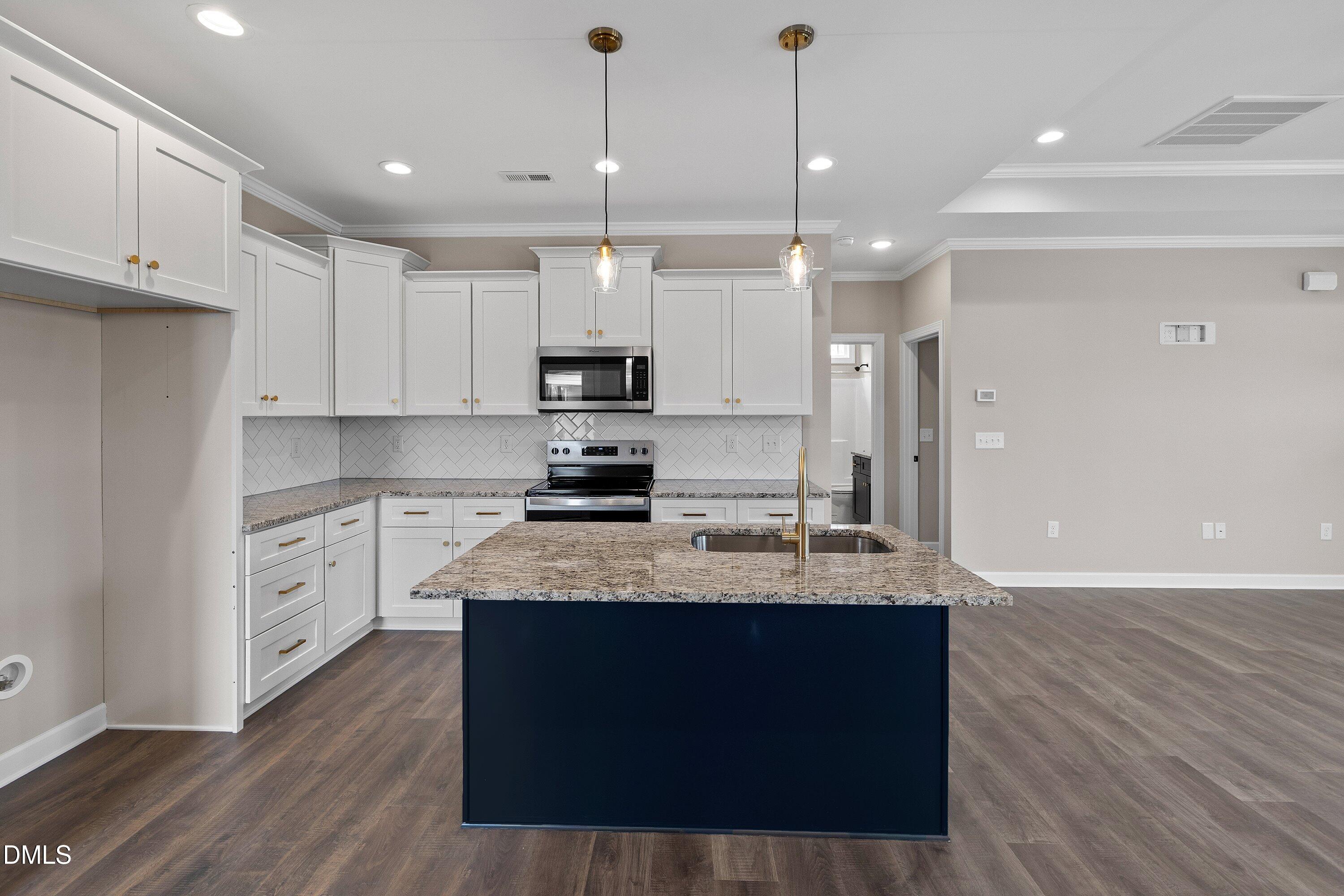 920 Micro Road West Selma, NC 27576 - Photo 13 of 32 a large kitchen with stainless steel appliances granite countertop a sink a stove and a refrigerator