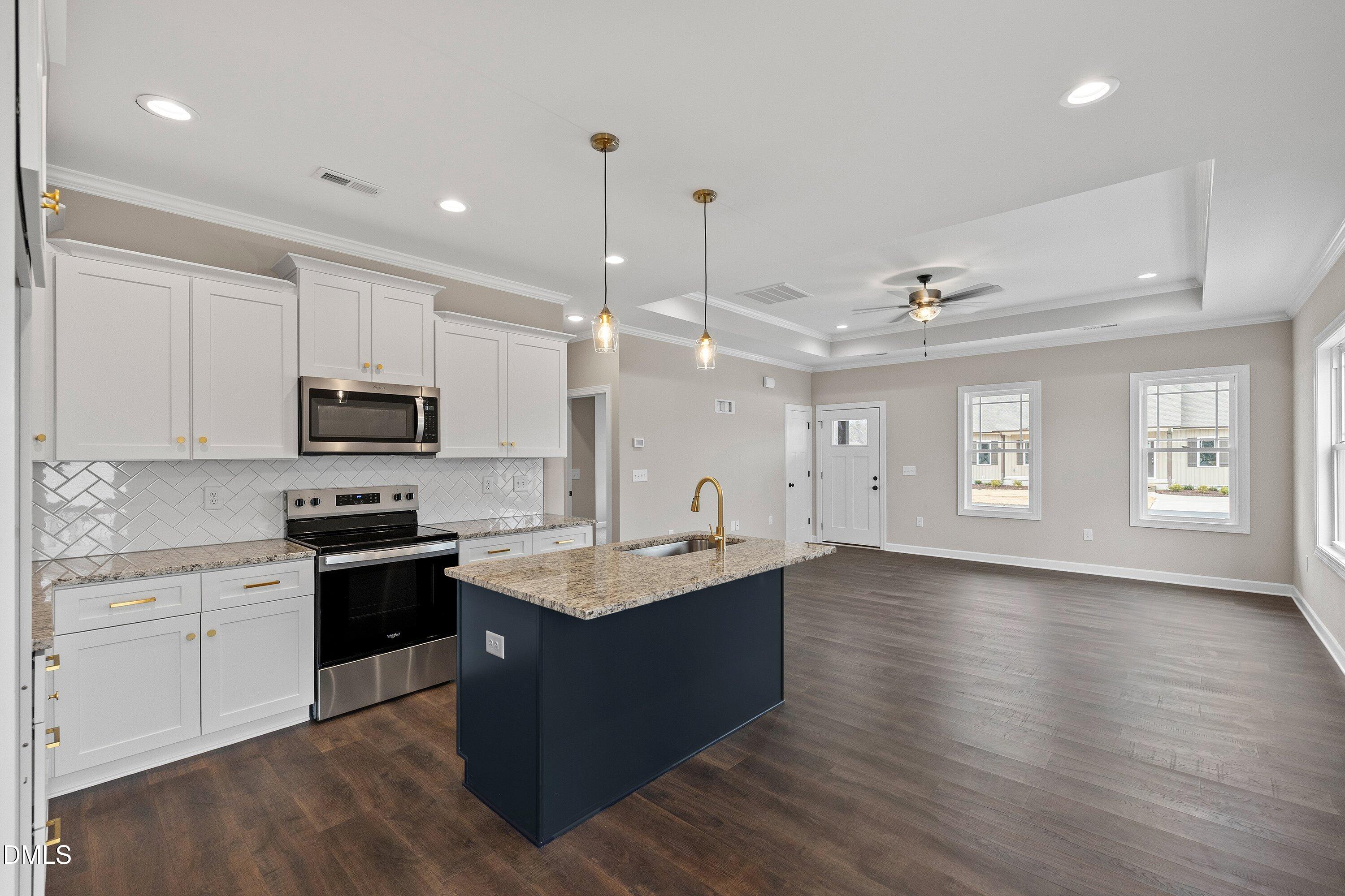 920 Micro Road West Selma, NC 27576 - Photo 14 of 32 a kitchen with stainless steel appliances granite countertop a sink stove and wooden floor