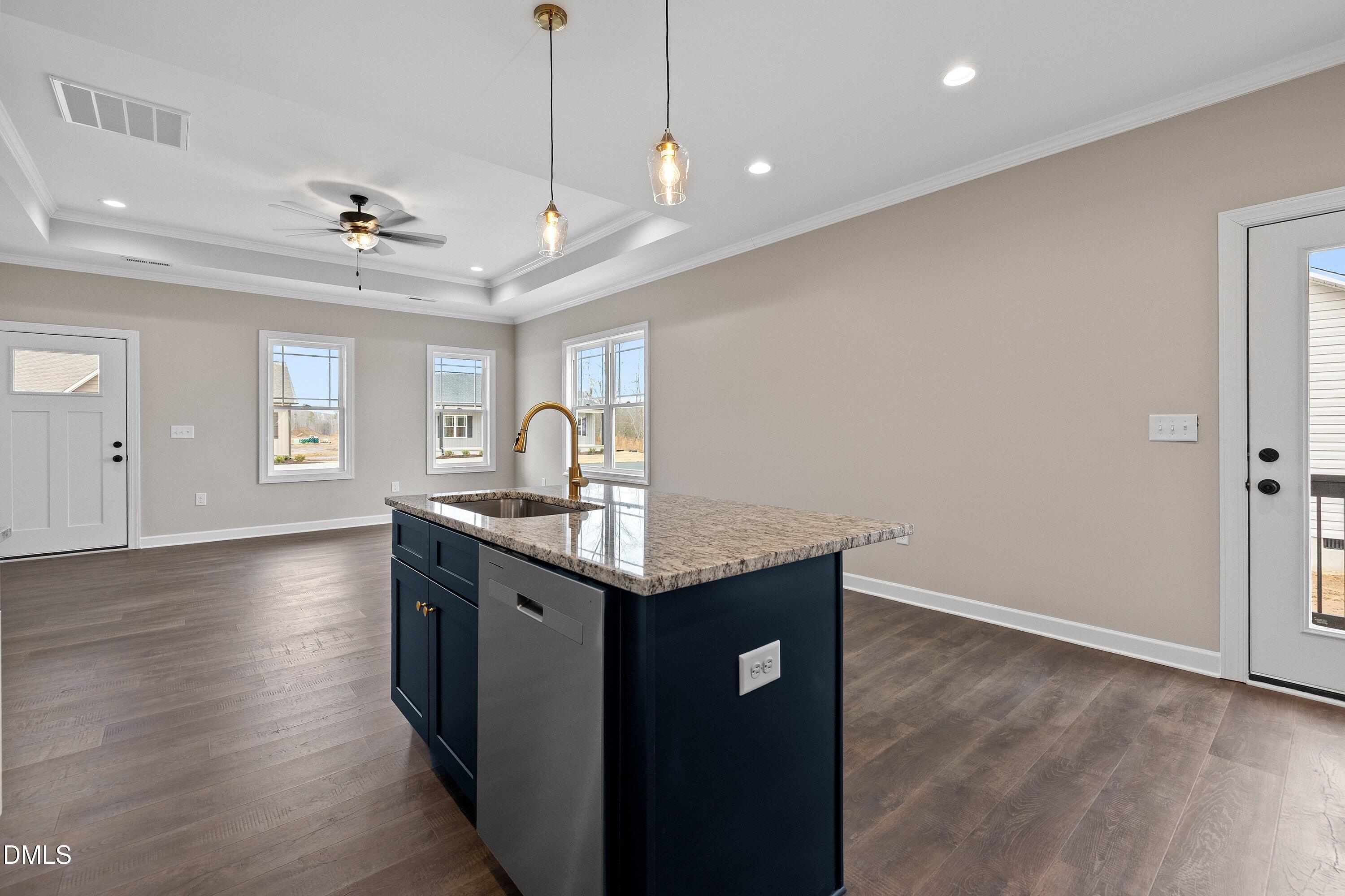 920 Micro Road West Selma, NC 27576 - Photo 17 of 34 a kitchen with stainless steel appliances granite countertop a sink a stove a refrigerator and island with wooden floor