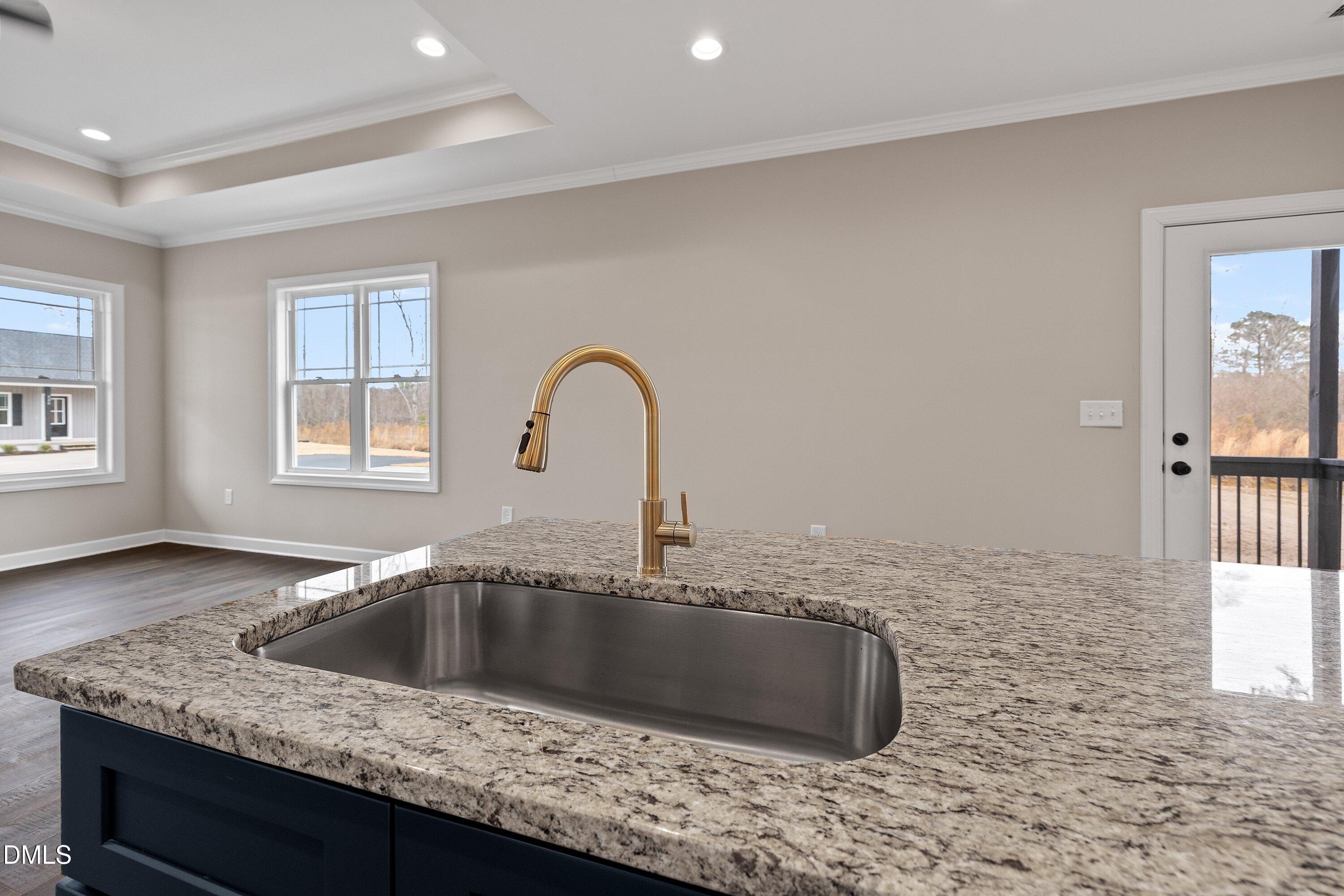 920 Micro Road West Selma, NC 27576 - Photo 18 of 32 a kitchen with a sink granite counter tops and a granite counter tops