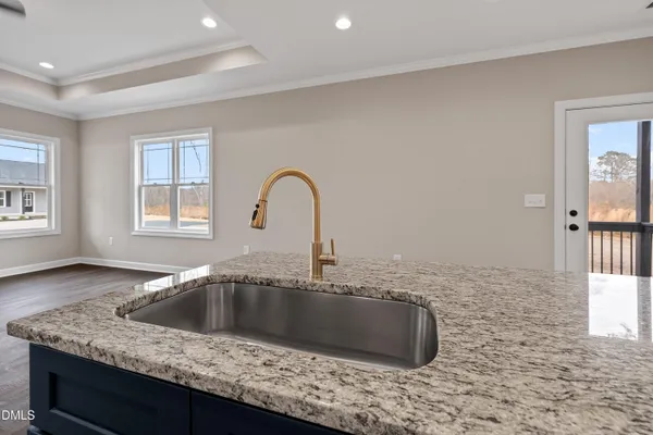 a bathroom with a granite countertop sink a toilet and shower