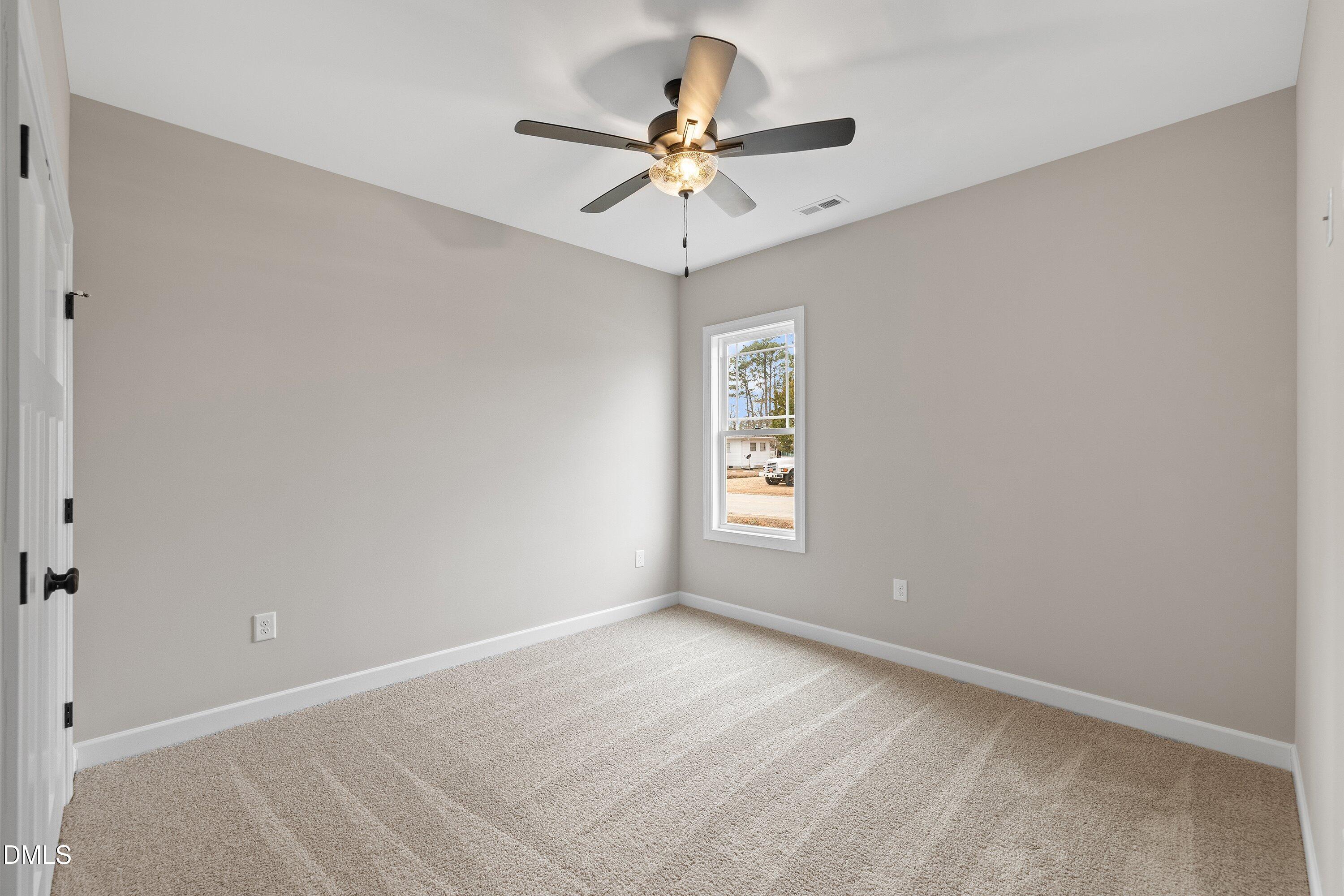 920 Micro Road West Selma, NC 27576 - Photo 21 of 34 a view of a room with a ceiling fan and window