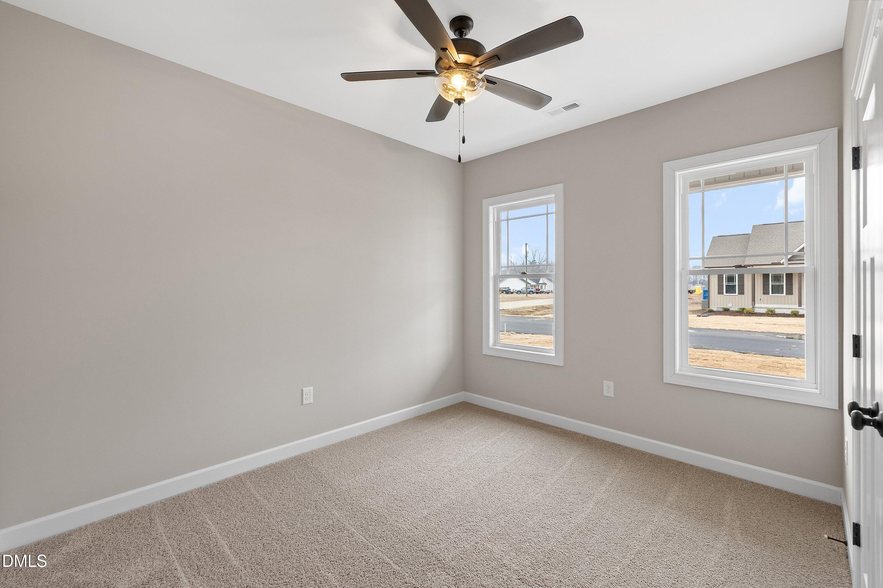 920 Micro Road West Selma, NC 27576 - Photo 23 of 34 an empty room with a window and a fan