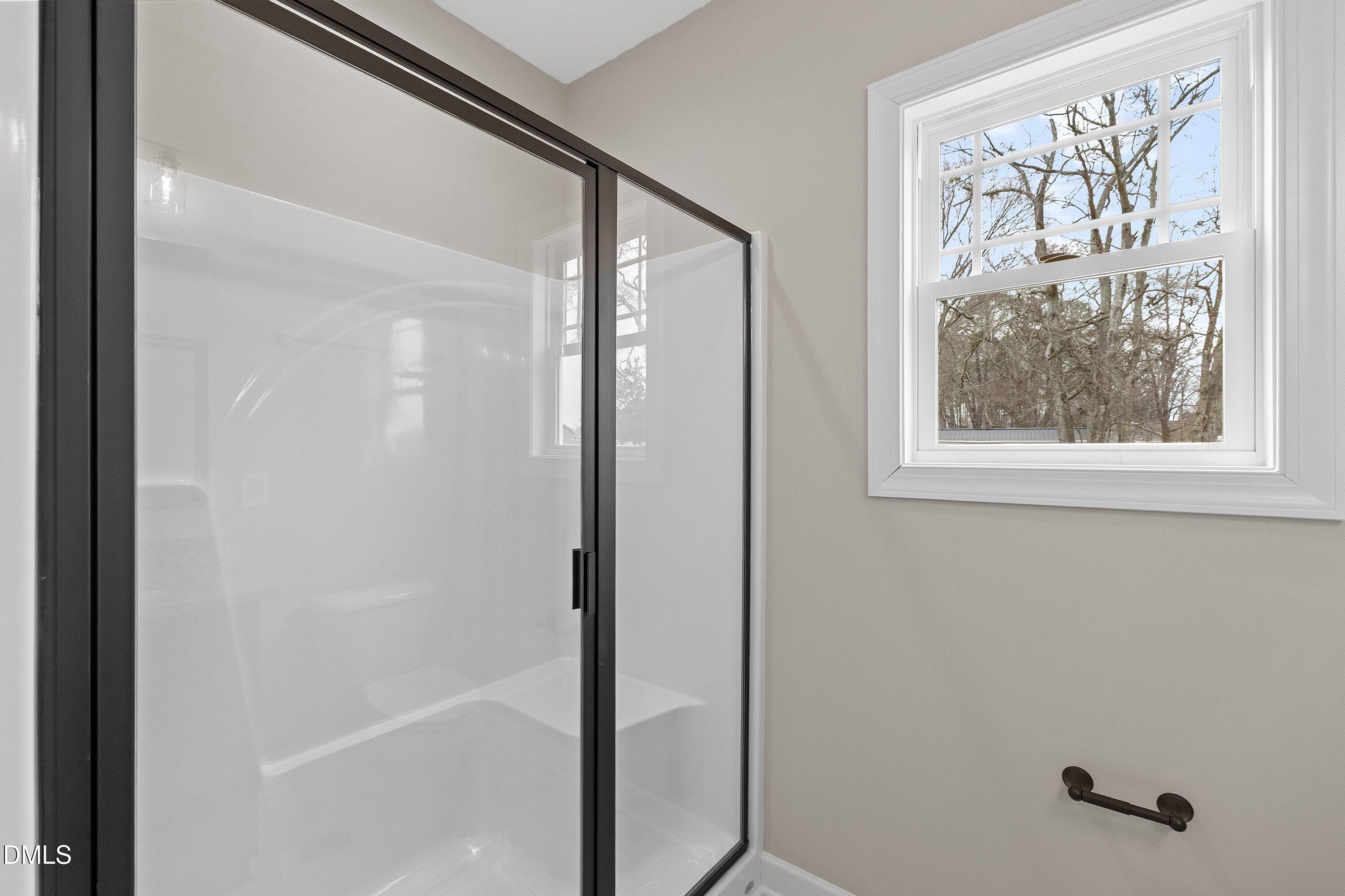 920 Micro Road West Selma, NC 27576 - Photo 26 of 32 a bathroom with a glass shower door