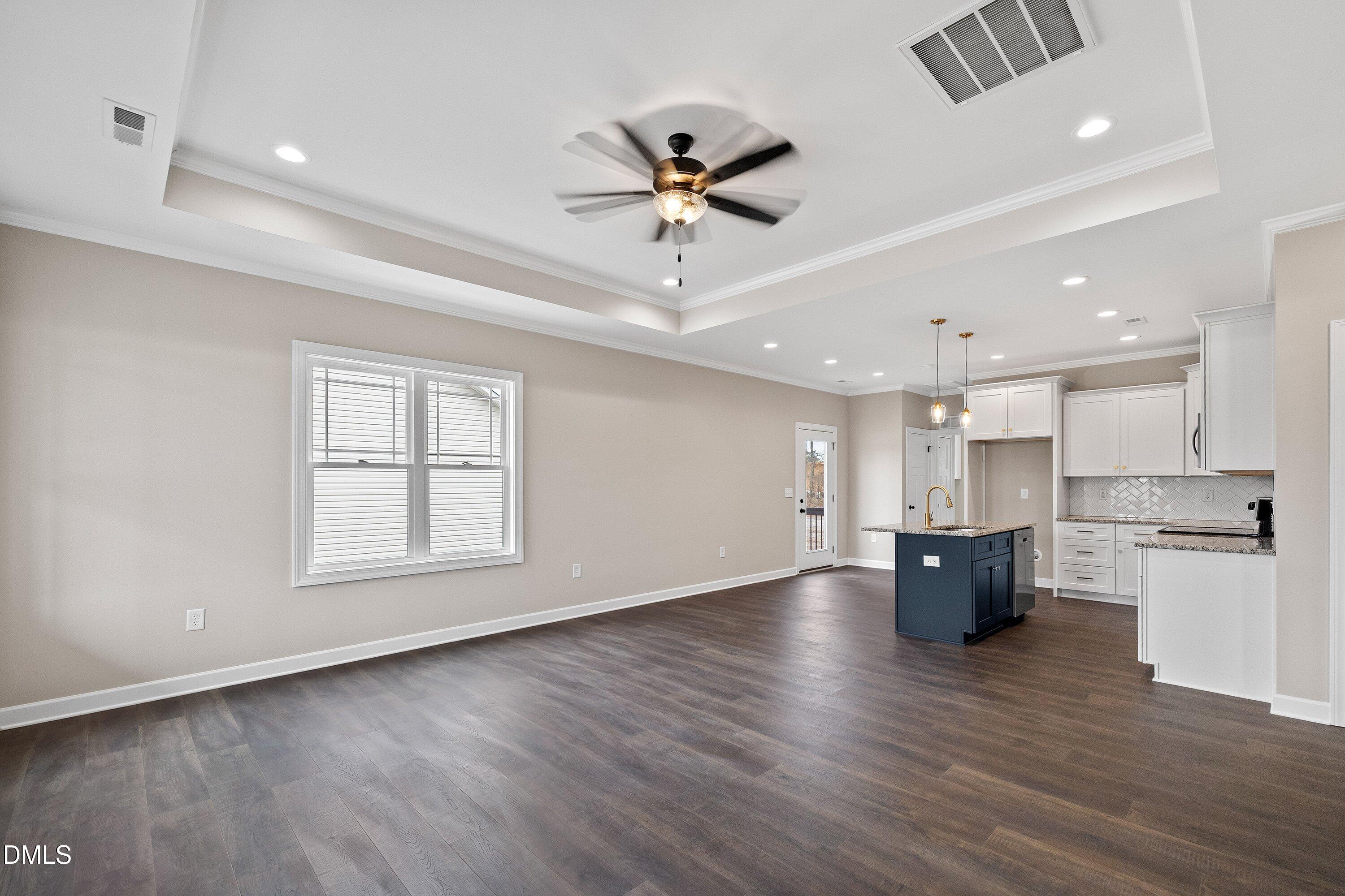 920 Micro Road West Selma, NC 27576 - Photo 6 of 32 a view of an empty room with kitchen appliances and a ceiling fan