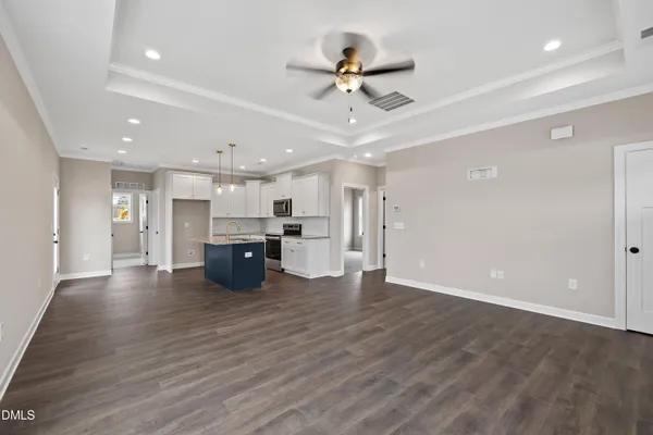 a kitchen with stainless steel appliances kitchen island granite countertop a refrigerator a sink and a stove