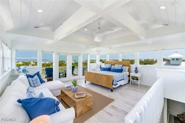 a bedroom with furniture and a large window