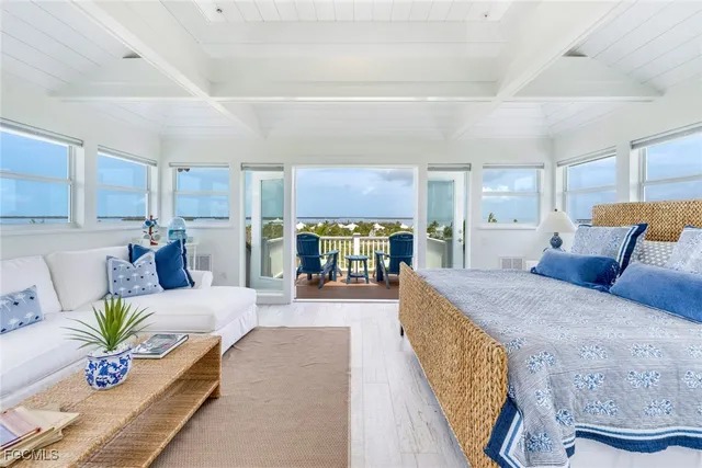 a large bedroom with a large bed and a large window