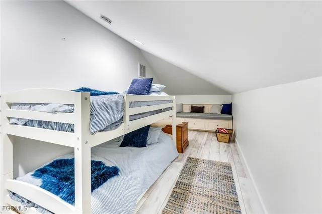 a bedroom with furniture and a large window