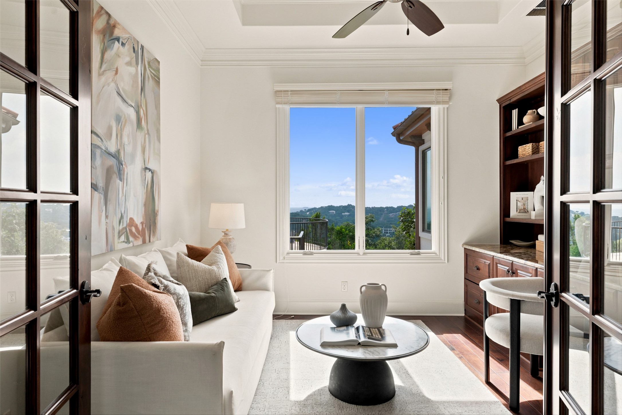 1414 The High Road Austin, TX 78746 - Photo 21 of 40 A well-lit sitting room or office space, offering sweeping views of the surrounding hills from its elevated position.