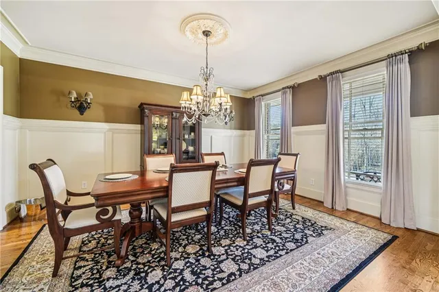 a kitchen with stainless steel appliances granite countertop a sink a stove and a wooden floors