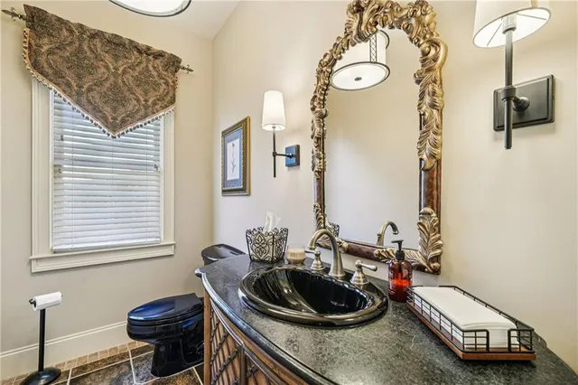 a kitchen with stainless steel appliances granite countertop a kitchen island a stove a sink and a microwave