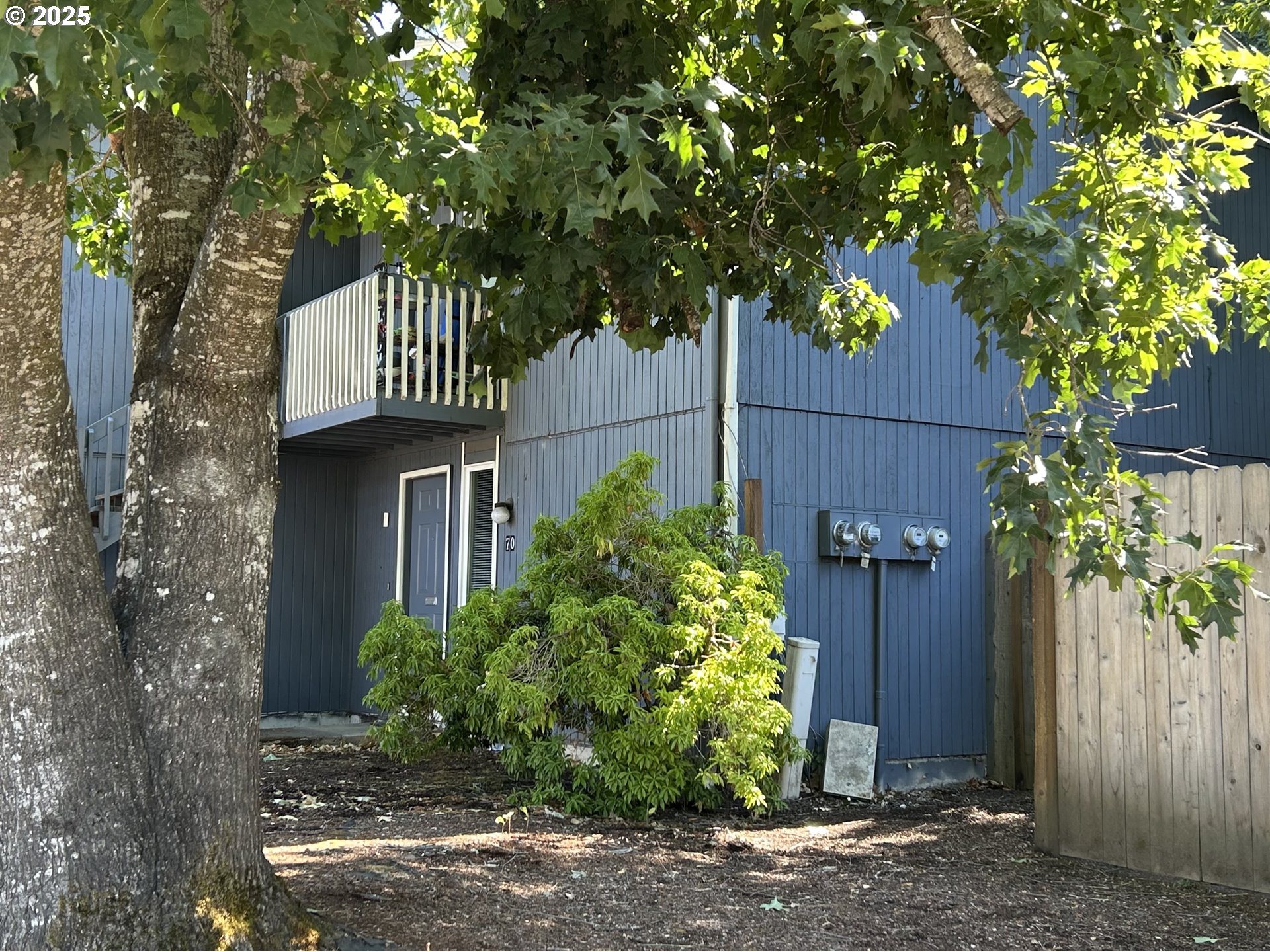 5495 A Units 69 70 71 72 Street Springfield, OR 97478 - Photo 3 of 13 a front view of a house with a tree