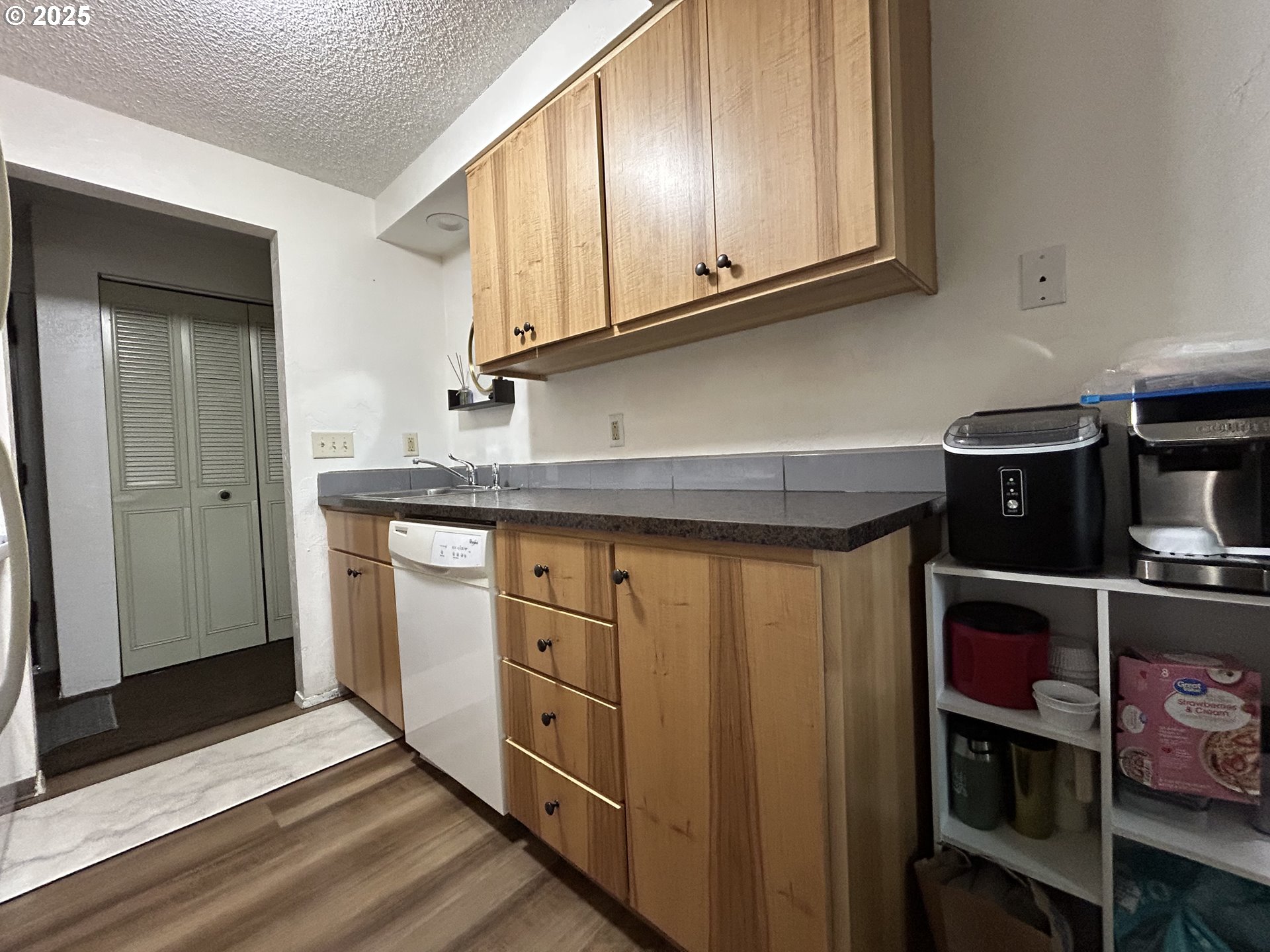 5495 A Units 69 70 71 72 Street Springfield, OR 97478 - Photo 5 of 13 a kitchen with stainless steel appliances granite countertop a refrigerator and cabinets