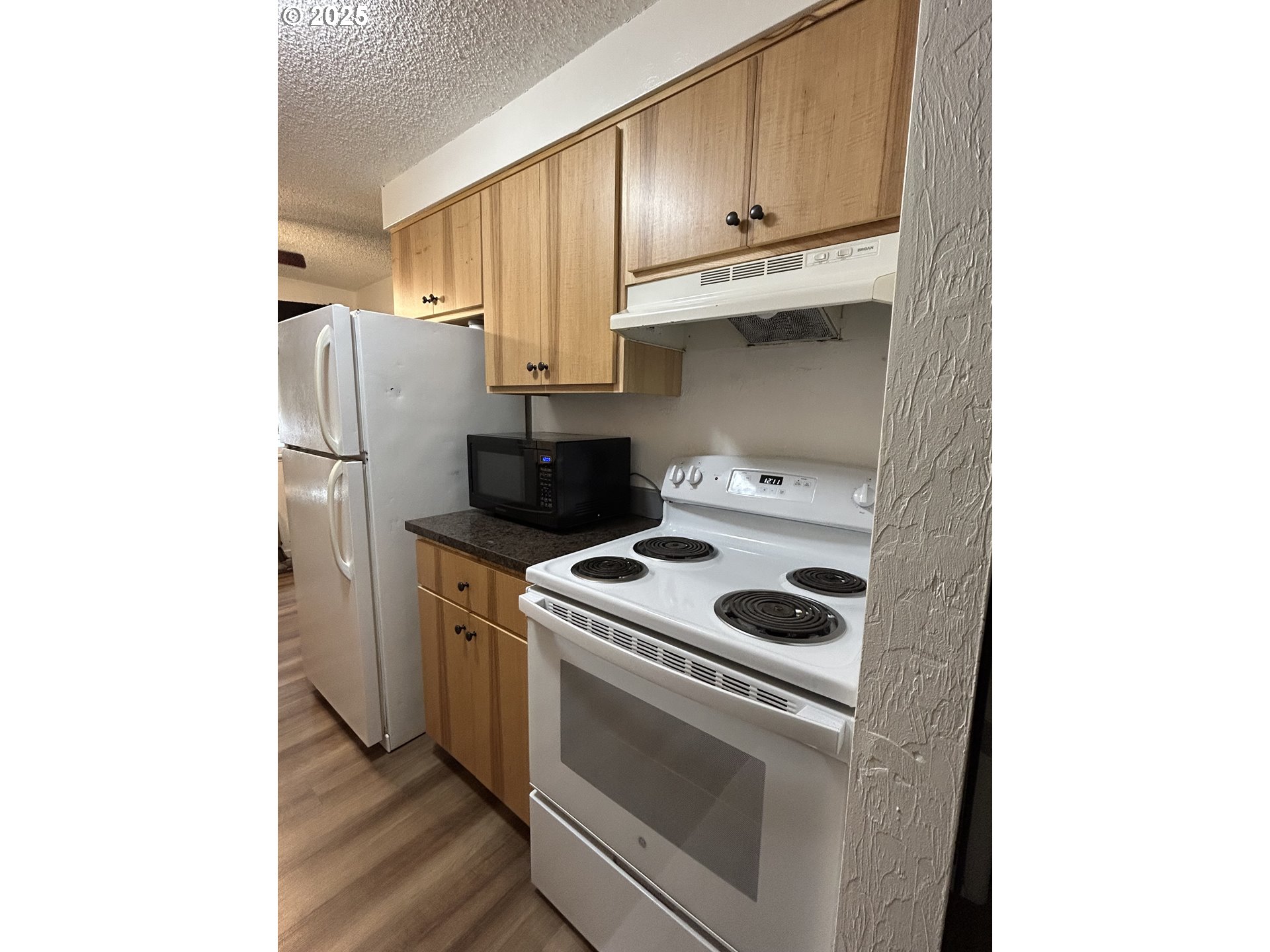5495 A Units 69 70 71 72 Street Springfield, OR 97478 - Photo 8 of 13 a kitchen with a stove top oven and refrigerator