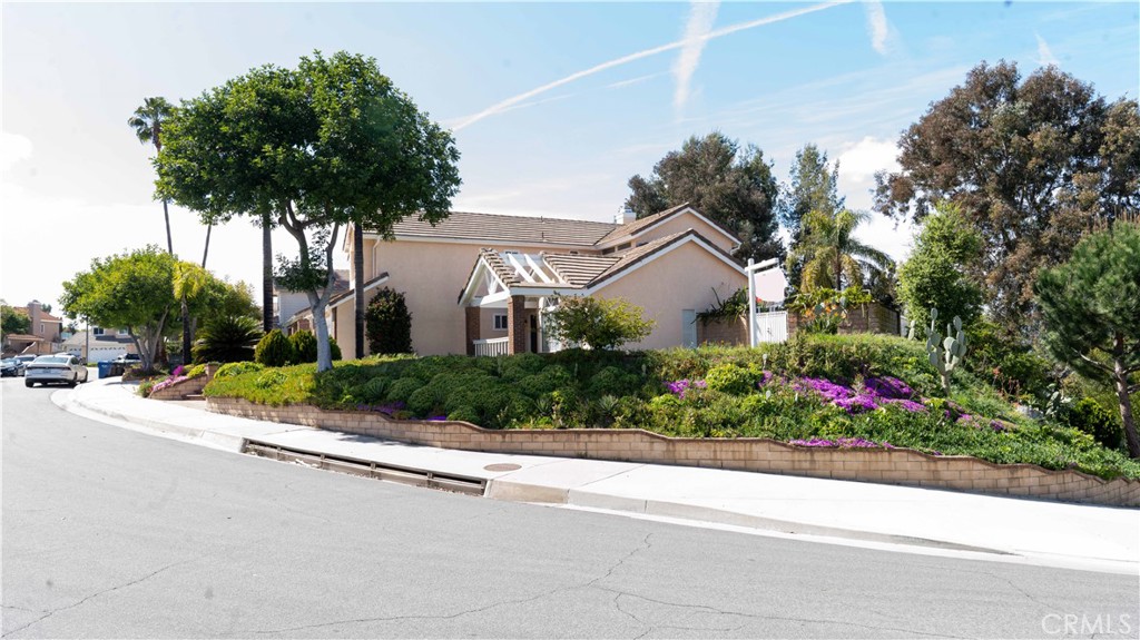 2409 Coraview Lane Rowland Heights, CA 91748 - Photo 17 of 23 a front view of a house with a garden and a tree