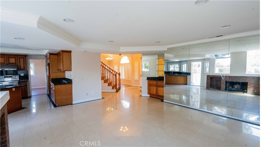 2409 Coraview Lane Rowland Heights, CA 91748 - Photo 9 of 23 a view of a living room and kitchen with furniture and a fireplace