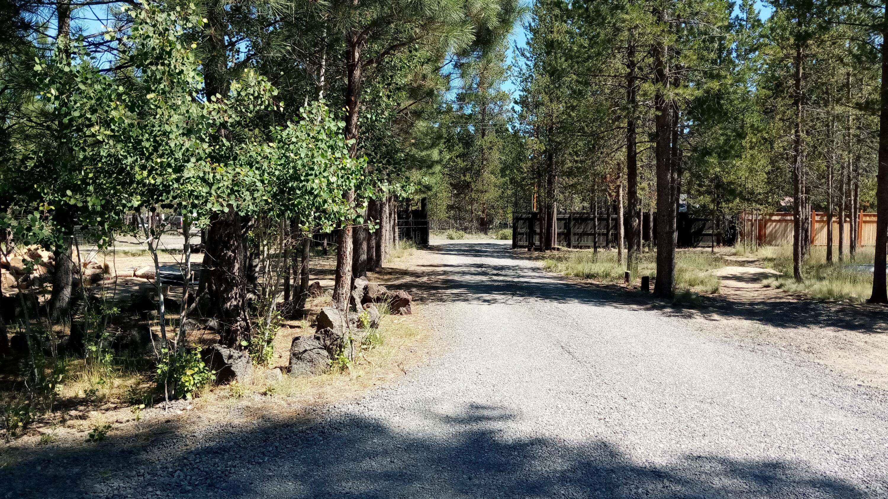 6616 Randy Road La Pine, OR 97739 - Photo 2 of 32 Property is fenced and gated, privacy fencing across front, circular, gated drive.