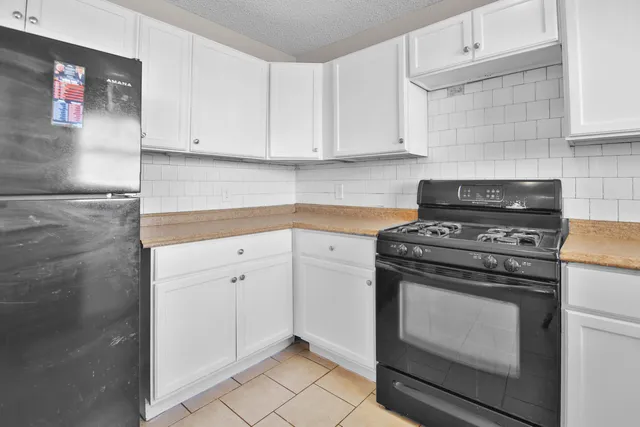 a kitchen with cabinets and appliances