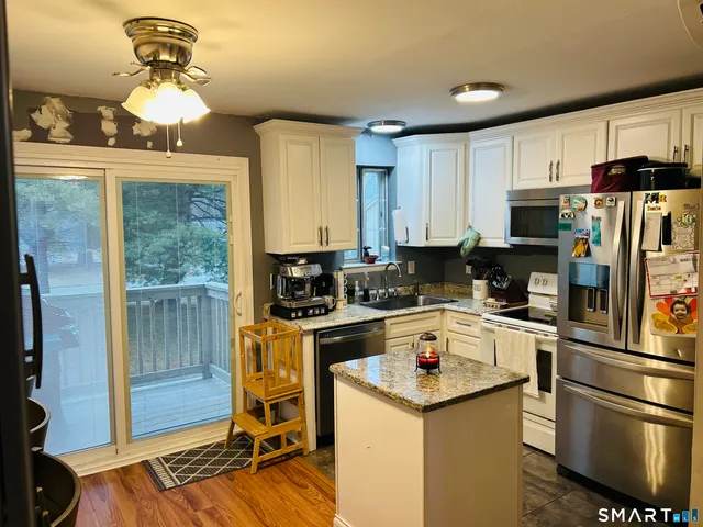 a kitchen with a stove a sink and a refrigerator