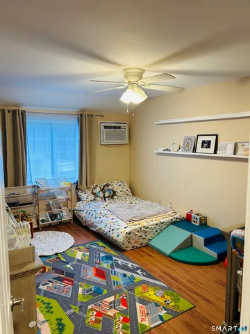 a bedroom with a bed and a dresser in it