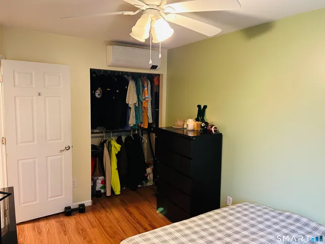 a bed room with a bed and a mirror