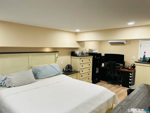 a bedroom with a bed and dresser