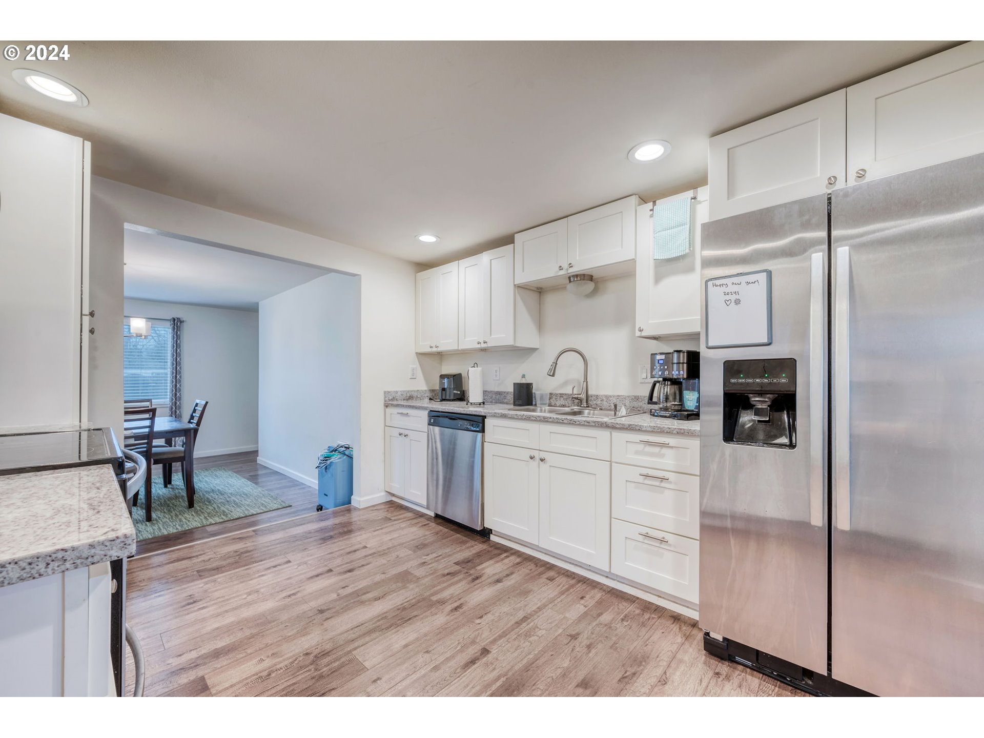2700 C Street Springfield, OR 97477 - Photo 11 of 30 a kitchen with granite countertop a refrigerator stove top oven and cabinets