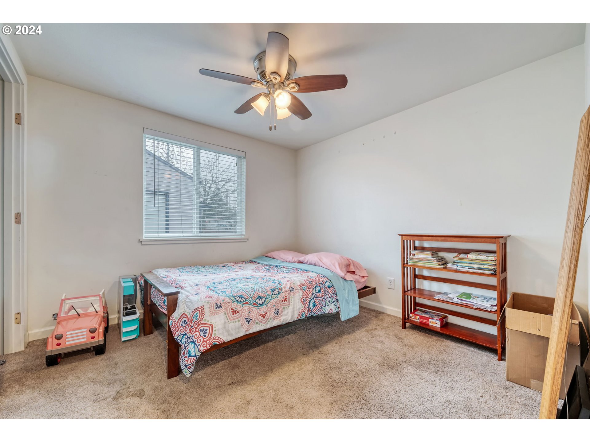 2700 C Street Springfield, OR 97477 - Photo 19 of 30 a bedroom with a bed and a chandelier