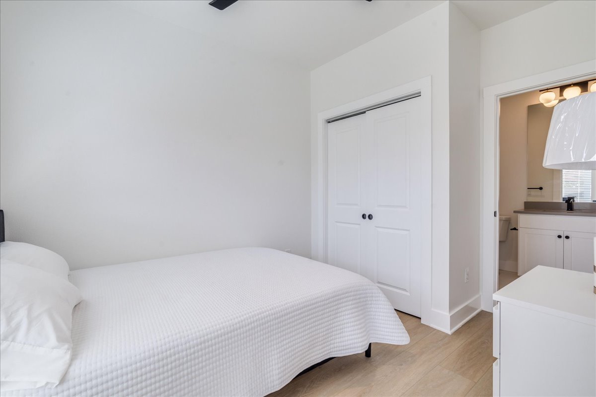 3000 Duval Street, Unit 102 Austin, TX 78705 - Photo 9 of 40 Bedroom featuring light wood-style flooring, a closet, and a ceiling fan
