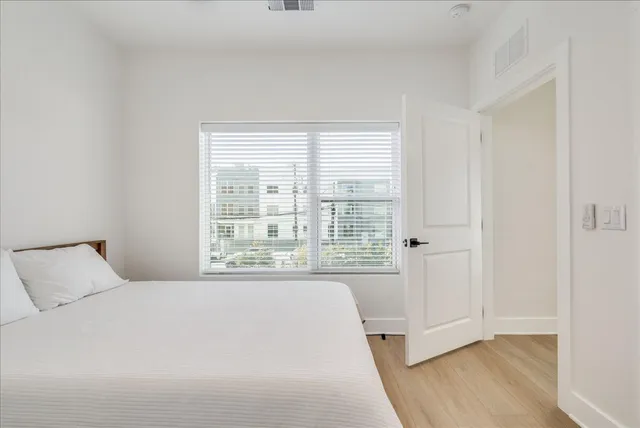 a bathroom with a bathtub shower sink vanity and toilet